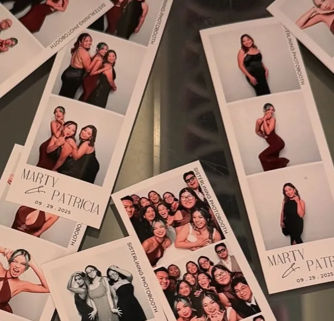 Printed photo strips from an event spread out on a table