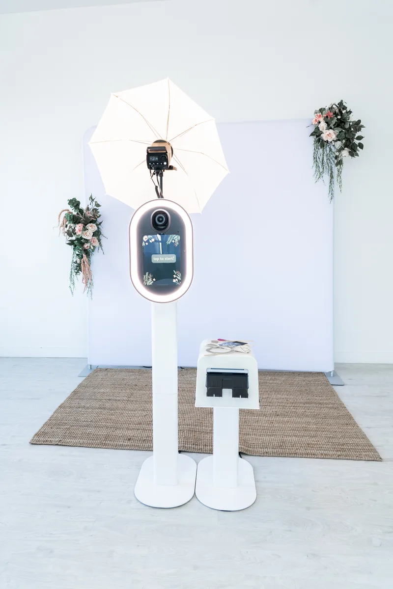 The booth styled against a floral backdrop