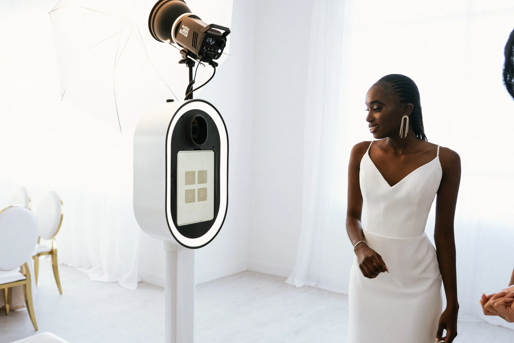 A bride standing beside the booth