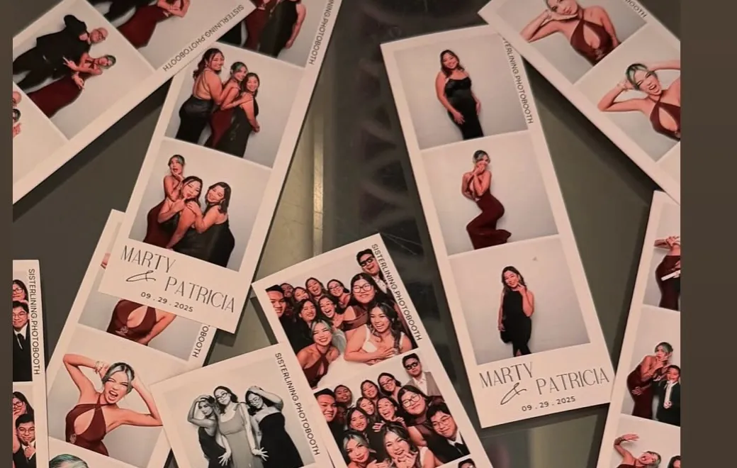Printed photo strips from an event spread out on a table