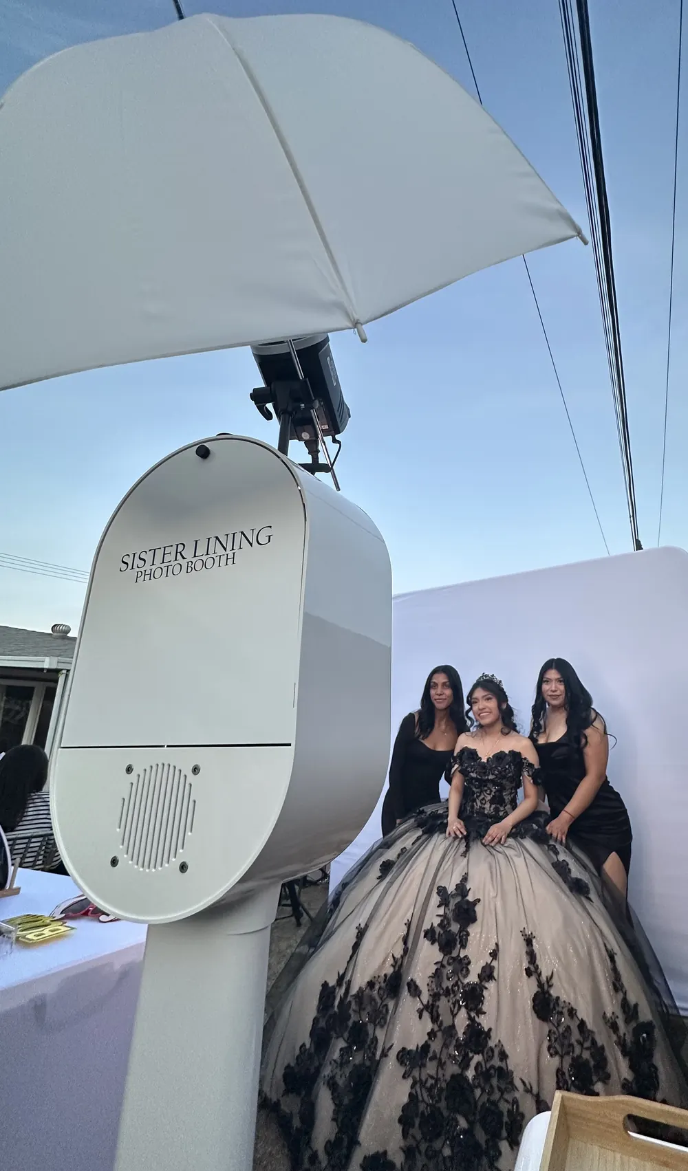 The booth set up outdoors beside guests in ballgowns